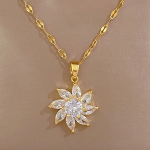 Close-up of titanium steel gold flower pendant necklace with micro-set sparkling crystals