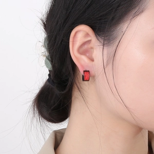 Red square zircon earrings in stainless steel on model with a glittering finish