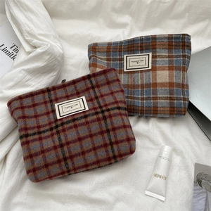 Detail of plaid wool vanity cases showing texture and Pleasant Time brand label