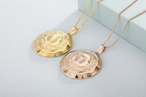 Detail of gold and rose gold textured round pendant necklaces with polished centers