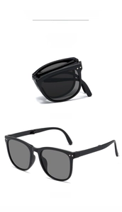 Detail view of foldable UV sunglasses with black frame and grey lenses in compact design