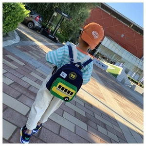 Detail view of cartoon school bus backpack featuring a unique yellow bus front pocket design