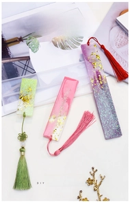 Detail of DIY bookmark silicone mold with epoxy resin samples and colorful tassels