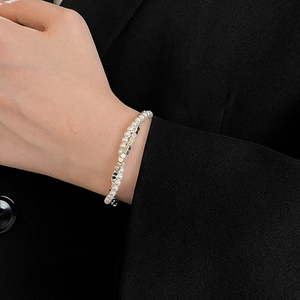 Double-layer pearl and silver metallic bead bracelet shown on a model's wrist