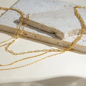 Triple-layered 18k gold plated stainless steel necklace with paperclip and twisted chains
