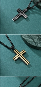 Detailed view of layered two-tone stainless steel cross pendants in black and gold