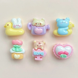 Close-up of cute cartoon resin charms set including rabbit, bear and home sign accessories