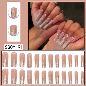 Long coffin press-on nails with nude pink gradient, butterfly patterns, and silver glitter