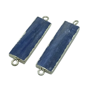 Detail of natural blue kyanite rectangular connectors with gold plated metal edges