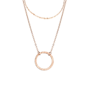 Close-up of double-layer stainless steel necklace with rose gold hammered round pendant