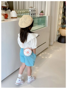 Cute pink donut-shaped crossbody bag styled with a girls casual summer outfit