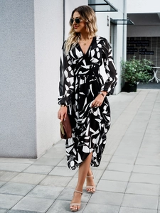 Chic long sleeve V-neck dress with black and white print and waist tie for vacations
