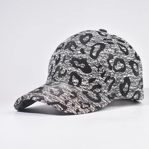 Detailed close-up of the black lace animal pattern and mesh texture on the baseball cap