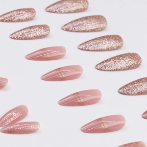 Sparkly rose gold glitter and pink almond press-on nails with minimalist gold lines