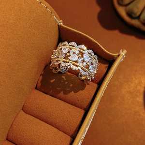 Detail showing two-tone hollow lace ring with pear-shaped cubic zirconia in a velvet box