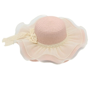 Detail of pink straw sun hat featuring wavy mesh brim and a delicate white lace bow