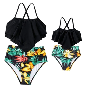 Detail of ruffle bikini sets for mother and child with tropical floral high waist bottoms