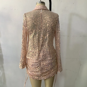 Detailed view of pink sequin mesh two-piece set featuring lapel jacket and drawstring mini skirt