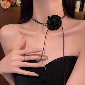 Detail shot of the elegant black fabric flower choker necklace with long ribbon ties