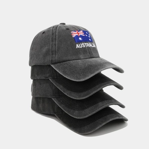 Close-up of Australia flag embroidery on stack of washed cotton baseball caps
