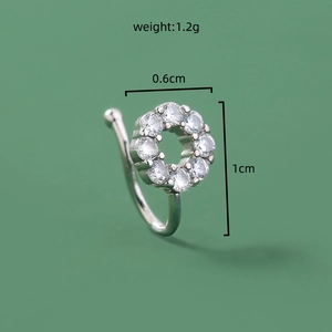 Macro shot of silver nose ring with cubic zirconia flower and size specifications