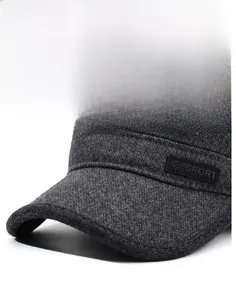 Detail of grey men's winter cap showing thick twill fabric and Sport leather patch