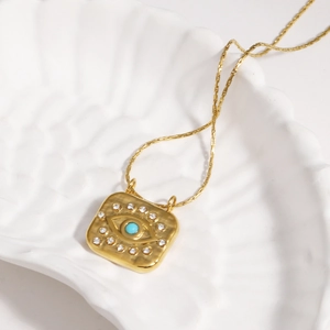 18k gold plated evil eye square pendant necklace with turquoise and crystals on shell dish