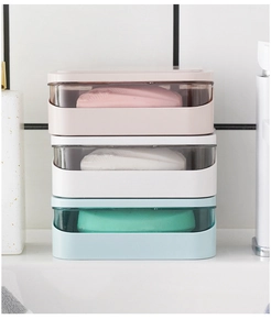 Three-layer bathroom soap storage box in pink, white, and blue with transparent lids