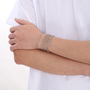 Detail showing four silver-toned stainless steel twist rope bracelets in varying thicknesses