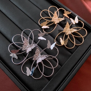 Close-up of vintage metallic butterfly earrings in silver and gold finishes on display