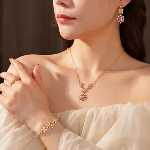 Vintage jewelry set with pink oval zircons and gold floral necklace, earrings and ring