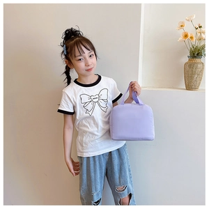 Detail of lavender insulated fabric lunch bag held by a child model in a clean setting