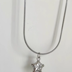 Silver snake chain necklace featuring a sparkling star pendant with clear crystals