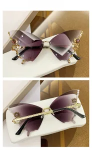 Detail view of butterfly shaped sunglasses with purple gradient lenses and rhinestone accents