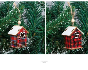 Detail of wooden Christmas house pendants with red plaid NOEL and JOY patterns