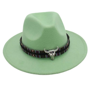 Detail of mint green wool felt fedora with ethnic woven band and silver bull skull charm
