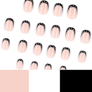 Minimalist black French press-on nails with white polka dots on nude pink base