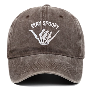 Detailed close-up of Stay Spooky embroidery on brown washed vintage baseball cap