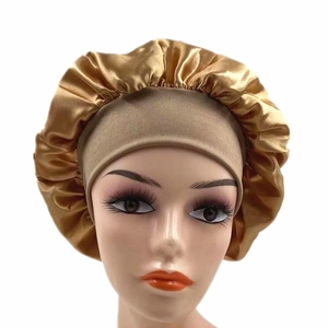 Detail of high-elastic wide-brim golden satin sleep cap on a mannequin head