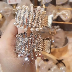 Elegant gold metal claw hair clip set with white pearls and sparkling rhinestones
