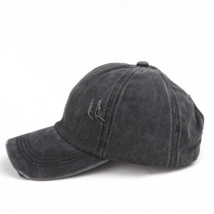 Detail view of washed grey baseball cap featuring vintage distressed holes and frayed edges