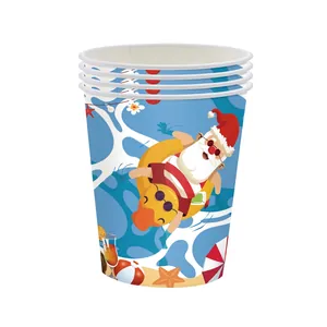 Stack of Summer Christmas party paper cups with Santa beach and palm leaf illustrations