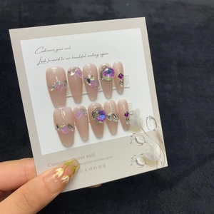 Handmade shimmer pink press-on nails with purple crystal rhinestones and tulip designs