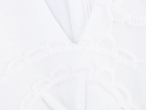 Détails macro de la broderie en dentelle blanche et fermeture éclair invisible de la robe