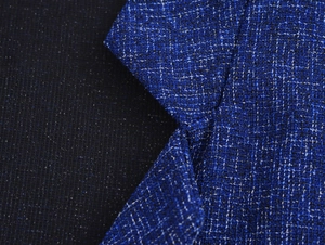 Macro shot of royal blue tweed fabric with woven white yarn and mesh contrast