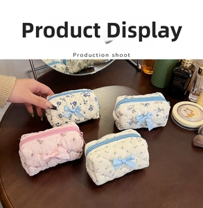 Close-up of quilted floral cotton mini pouches with ribbon bows and zipper closure