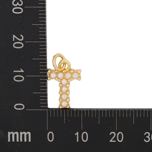 Macro view of gold letter T pendant with pearl inlays and precise size measurements