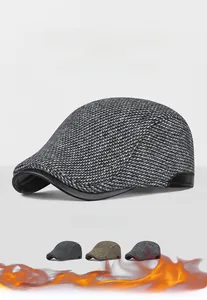 Detail of wool knit texture and leather brim on men winter flat cap with earflaps
