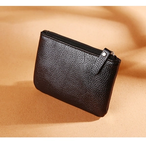 Detail of black litchi texture PU leather coin purse with side metal rivet and zipper