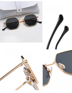 Detail view of octagon metal sunglasses with golden frame and durable hinges